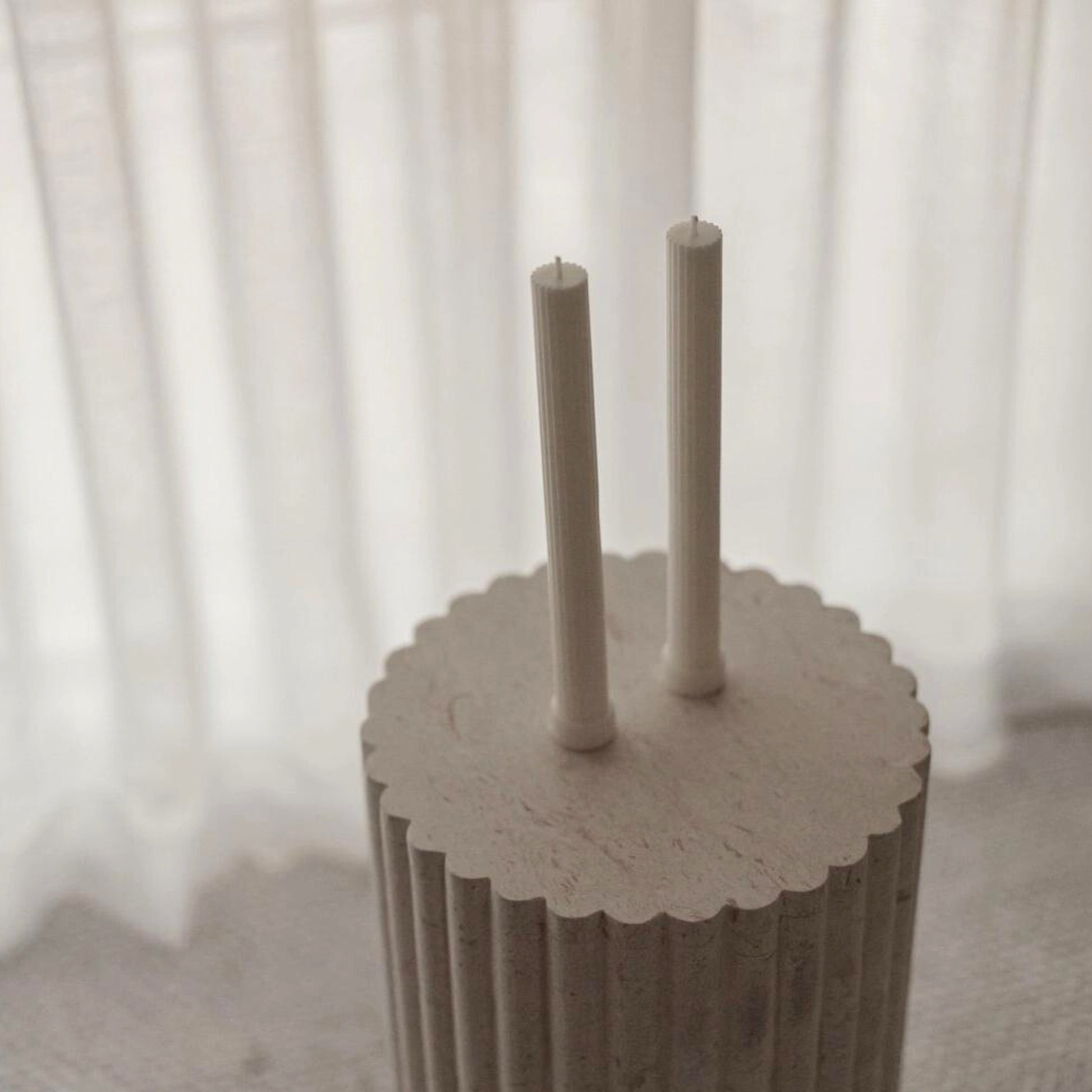 Pillar candles displayed on stone stand