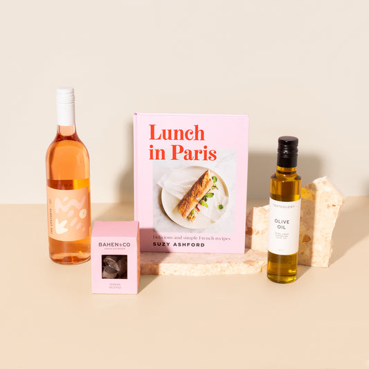 A chic gift hamper filled with rose wine , chocolate , French recipe book and olive oil curated as a housewarming gift, foodie gift, birthday gift  or corporate gift 